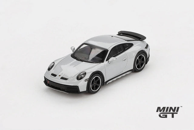 Mini GT Porsche 911 Dakar Ice Grey Metallic LHD prototype viewed from the front left showing the raised stance, black bonnet vents and black wheels
