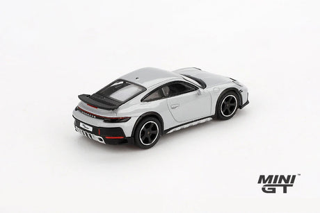 Mini GT Porsche 911 Dakar Ice Grey Metallic LHD prototype viewed from the rear left showing the rear light bar, black spoiler and raised body height