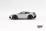 Porsche 911 Dakar Ice Grey Metallic LHD prototype in full side profile showing the black wheel arch trim, raised suspension and rear spoiler