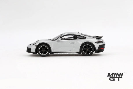 Porsche 911 Dakar Ice Grey Metallic LHD prototype in full side profile showing the black wheel arch trim, raised suspension and rear spoiler