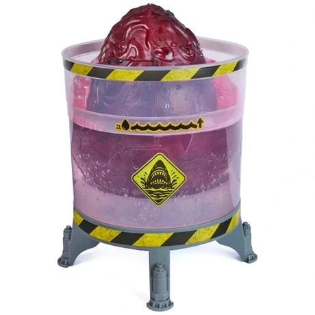 Dark red Primal Hatch Megalodon egg protruding from a transparent purple cylindrical hatching tank, with yellow and black hazard stripes, shark warning symbol and grey supporting legs.