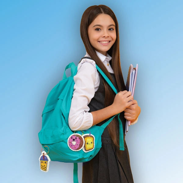 Puffy Art Foodies finished food keychains attached to a turquoise backpack