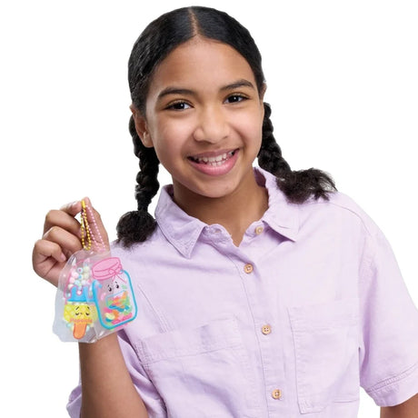 Girl holding finished Puffy Pouches candy accessories attached to bead chains