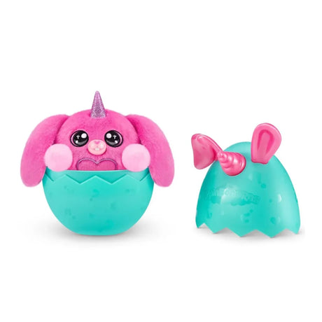 Pink Bunnycorn plush with glitter horn sitting inside cracked teal egg base with matching egg lid placed beside it