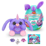 Purple Bunnycorn plush with glitter horn and long floppy ears sitting in front of teal Bunnycorn egg with collector card and three small bunny figures