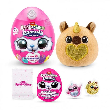 Tan Rainbocorns Eggzania Baby plush with gold glitter heart beside pink Eggzania egg with stickers and collector guide displayed below