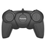 Black Porsche remote control handset with two round control pads and Porsche logo