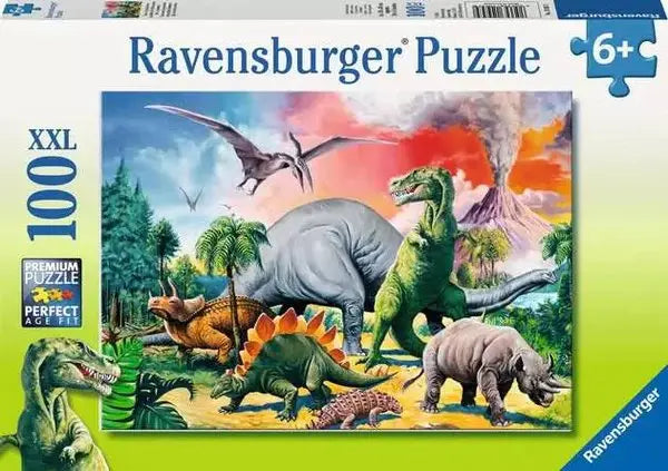 Ravensburger Among the Dinosaurs 100 piece XXL jigsaw puzzle box showing a prehistoric scene with T-Rex, stegosaurus, triceratops, pterodactyl, and erupting volcano