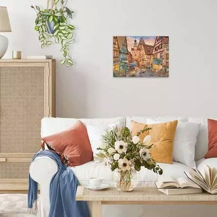 Completed Ravensburger Bavaria Illuminated puzzle displayed on a wall above a sofa