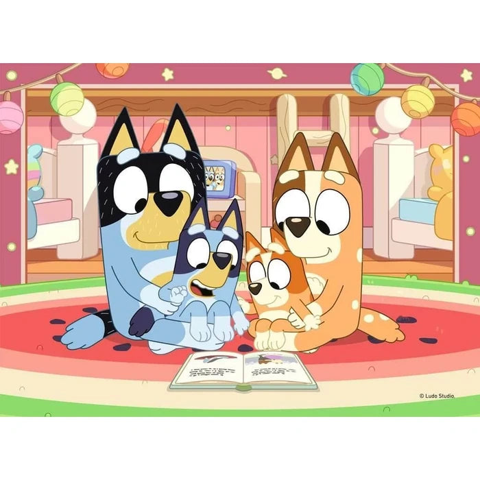 Ravensburger Bluey jigsaw with Bluey, Bingo, Chilli and Bandit reading together indoors
