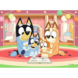 Ravensburger Bluey jigsaw with Bluey, Bingo, Chilli and Bandit reading together indoors