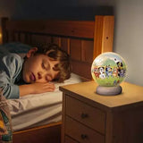 Ravensburger Bluey 3D Puzzle Night Light glowing on a bedside locker beside a sleeping child