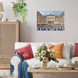 Completed Ravensburger Château de Versailles puzzle displayed on a living room wall above a white sofa