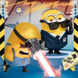 Ravensburger Despicable Me 4 puzzle scene with Minions in black suits and a glowing red device