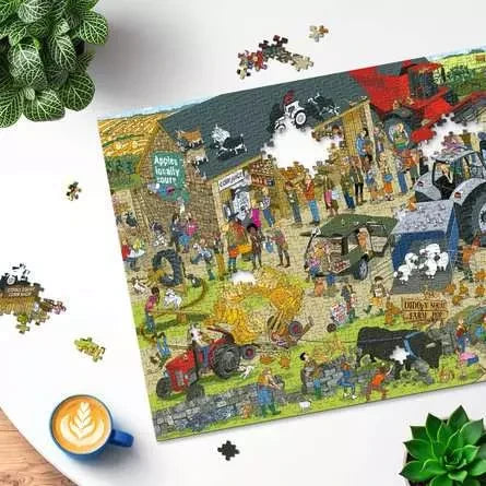 Ravensburger Diddly Squat Farm 1000 Piece jigsaw puzzle being assembled on a table with loose pieces around the puzzle