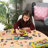 Child assembling the Ravensburger Donkey Kong 100 piece XXL jigsaw puzzle on a table with loose puzzle pieces nearby