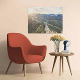 Completed Ravensburger The Great Wall of China jigsaw puzzle displayed on a wall above a chair and side table