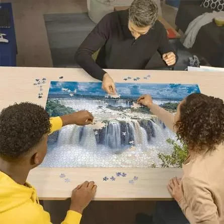 Three people building the Ravensburger Iguazu Waterfall 2000 Piece Jigsaw Puzzle