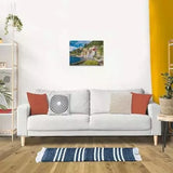 Completed Ravensburger Lake Como Italy puzzle displayed on a wall above a sofa