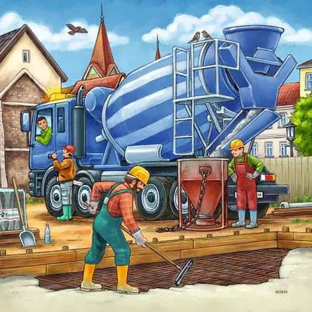 Blue cement mixer truck beside workers pouring concrete on a building site