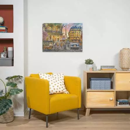 Ravensburger Paris at Dawn 1000 piece jigsaw puzzle displayed framed on a living room wall above a yellow chair