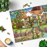 Ravensburger Rose Cottage 1000 Piece jigsaw puzzle partly assembled on a table with loose pieces around it