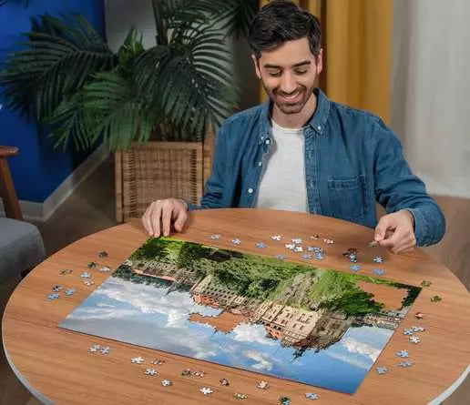 Ravensburger Sigmaringen Castle 1000 piece jigsaw puzzle in progress on a table with pieces being placed