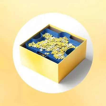 Blue sorting tray inside a yellow box with jigsaw pieces