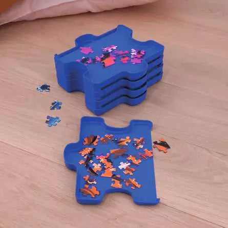 Stacked blue sorting trays with one tray filled with jigsaw pieces