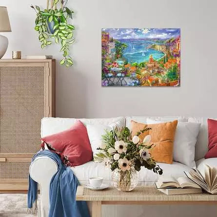 Completed St.Tropez jigsaw puzzle displayed on a wall above a sofa