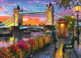 Ravensburger Tower Bridge at Sunset puzzle artwork showing Tower Bridge, a red telephone box, riverside path, flowers and a colourful evening sky