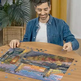 Man assembling the Ravensburger Tower Bridge at Sunset jigsaw puzzle on a table with loose pieces around the image