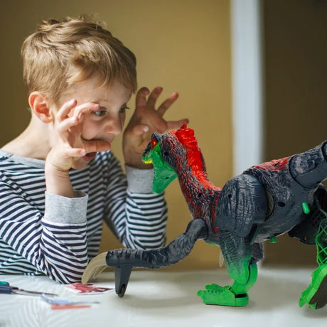 Child playing with remote control Therizinosaurus dinosaur toy in Ireland