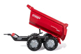 Red Rolly Halfpipe Krampe Trailer shown tipping its large round dump bed using the front handle on a white background.