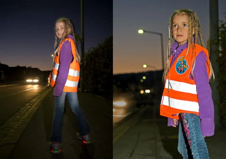Child wearing the Rolly Hi Vis Safety Vest while walking on a street at dusk with headlights in the background