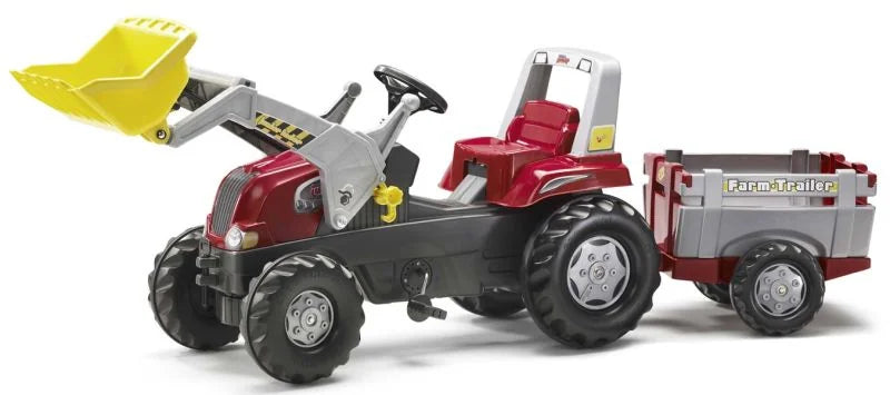 Rolly Junior red pedal tractor with front loader and farm trailer shown from the front on a white background