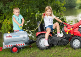 Two children using a Rolly tanker fitted with the blue pump and spraying water safely beside a lake