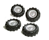 Group of four Rolly Trac air filled tyres with chunky tread and silver rims displayed on a white background