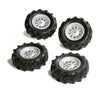 Four Rolly Trac air tyres with deep black tread and silver rims arranged on a white background