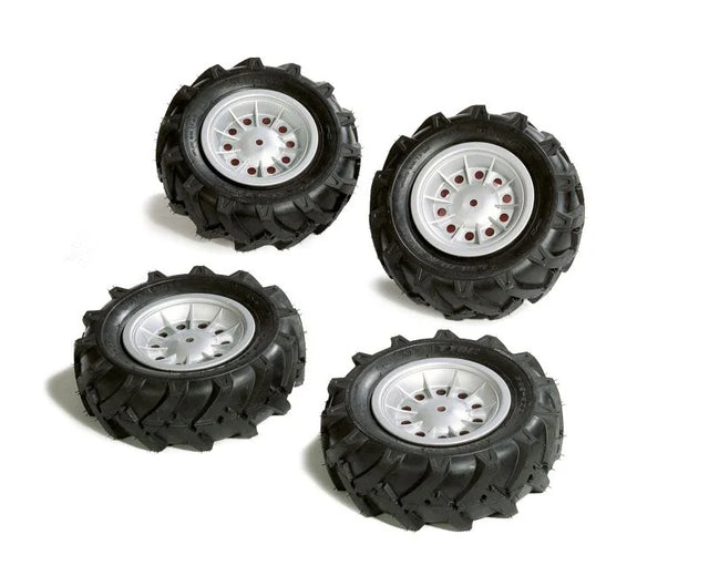 Four Rolly Trac air tyres with deep black tread and silver rims arranged on a white background