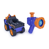 Mix's purple and orange construction vehicle beside the detached handheld blaster loaded with a translucent blue ball