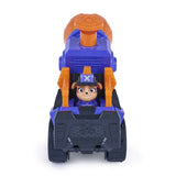 Mix seated behind the grey front bucket of the purple and orange Mega Blaster Vehicle with the launcher raised above the cab