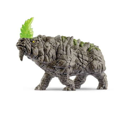 Left-facing side view of the Schleich Battle Rhino figure showing its raised translucent green horn, yellow eye and stone-like body texture