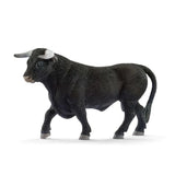 Schleich Black Bull figure with one front hoof raised and its long tail hanging beside the rear legs