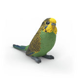 Schleich Budgie 14939 front right view showing the yellow head, green chest, patterned wings and long tail