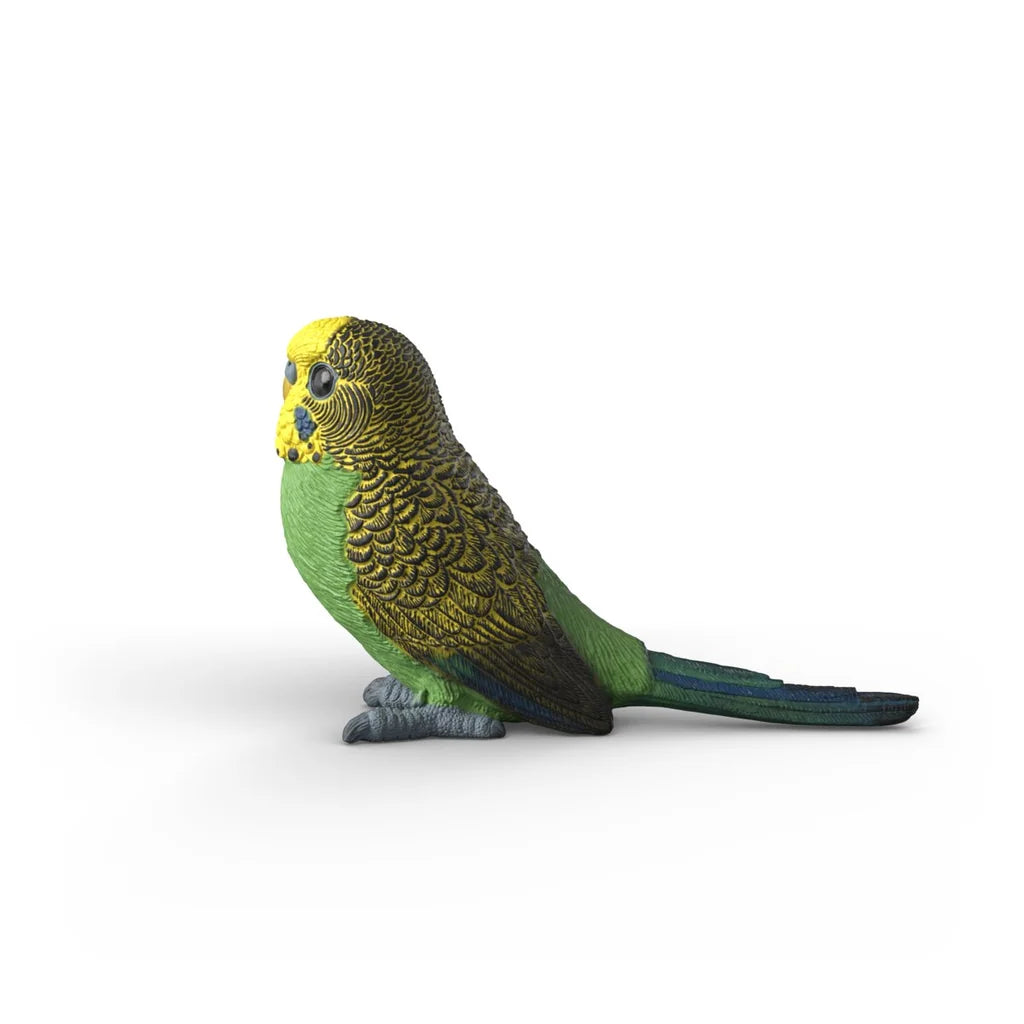 Schleich Budgie 14939 left side view showing the green body, yellow head, dark wing markings and long tail