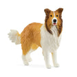 Schleich Collie figure with a long brown and white coat, upright ears, open mouth and raised bushy tail