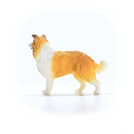 Schleich Collie figure shown from the left side with a white chest, open mouth and one front leg raised