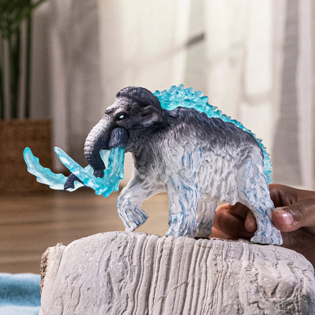 Schleich Frost Mammoth figure held on a textured block with translucent blue tusks and blue markings on its legs