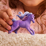 Child holding Schleich Galaxy Rainbow Unicorn Foal 70843